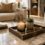 Brown marble tray on coffee table styled with candle, succulent and gold stirrer in a luxury living room