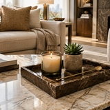 Brown marble tray on coffee table styled with candle, succulent and gold stirrer in a luxury living room